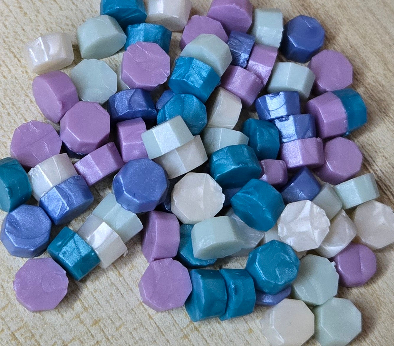 dreamy blend of pearlescent teal, blue, ivory, and purple wax seal beads that shimmer like springtime sunrise over a stained glass chapel.