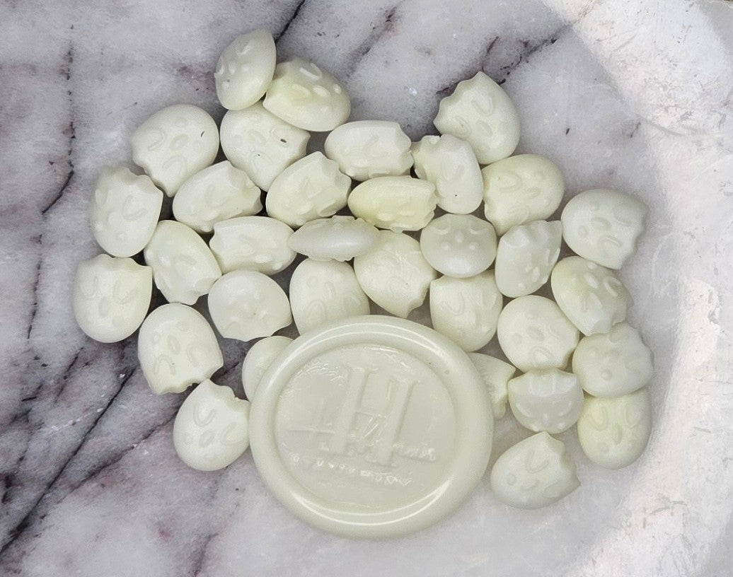 a luminous white wax seal bead that radiates a soft, ethereal glow in the dark, adding a touch of magic to every seal