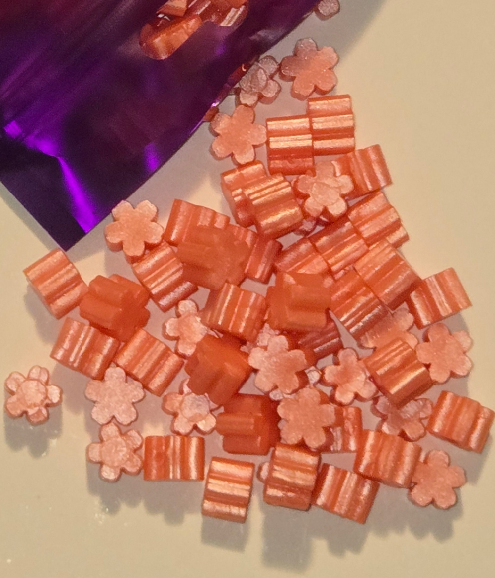 a zesty coral-pink wax seal bead with a juicy vibrance and a tangy twist, radiating citrusy charm