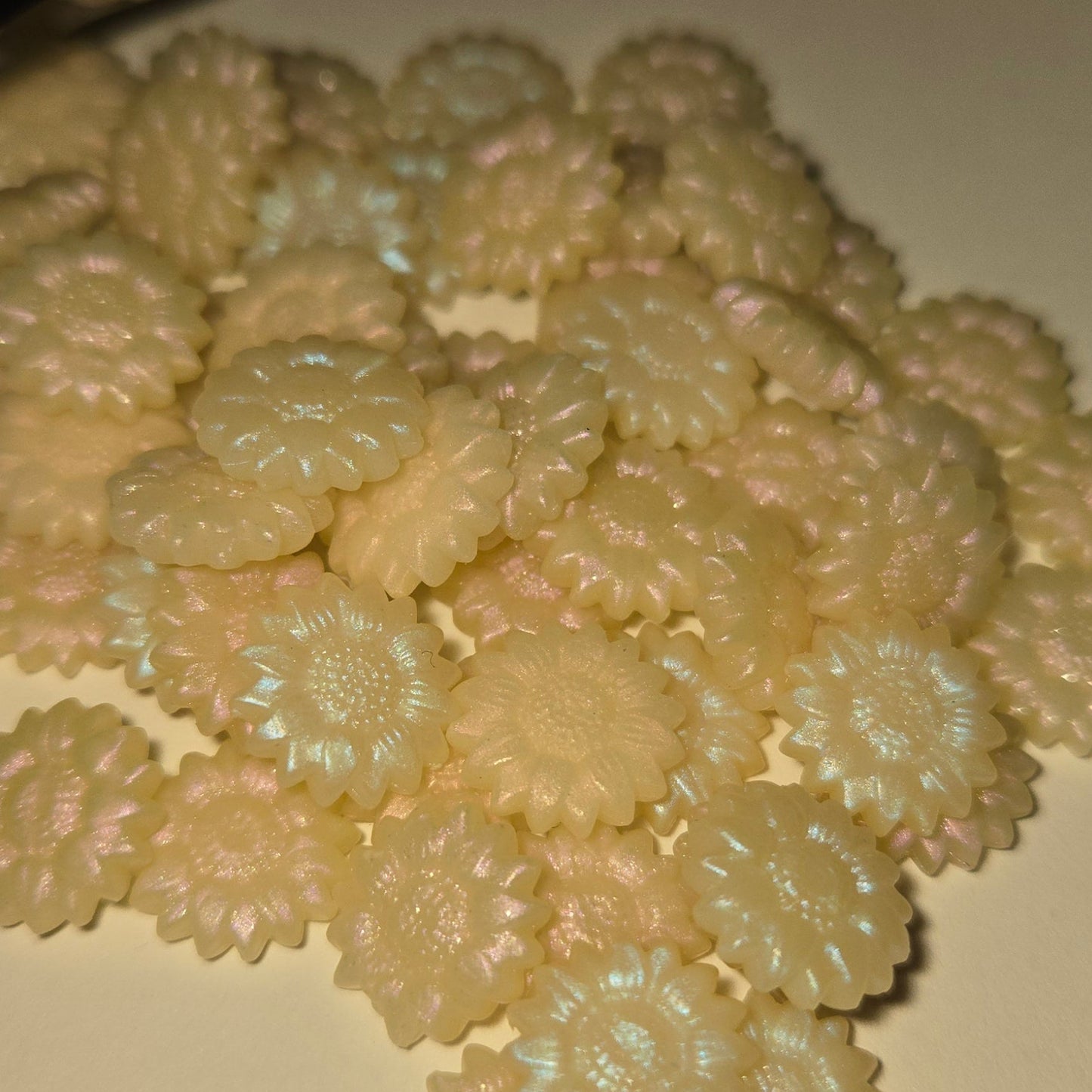 Kaleidoscope — A luminous white wax kissed with shifting iridescent halos of pink, green, purple, and blue.