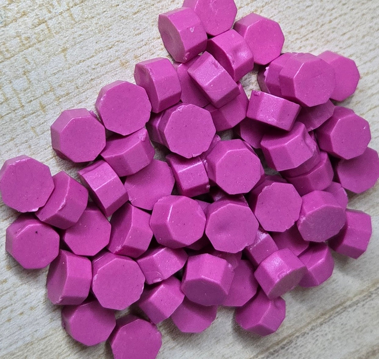 velvety medium pink wax seal bead with a smooth, shine-free finish that evokes classic elegance and confident charm