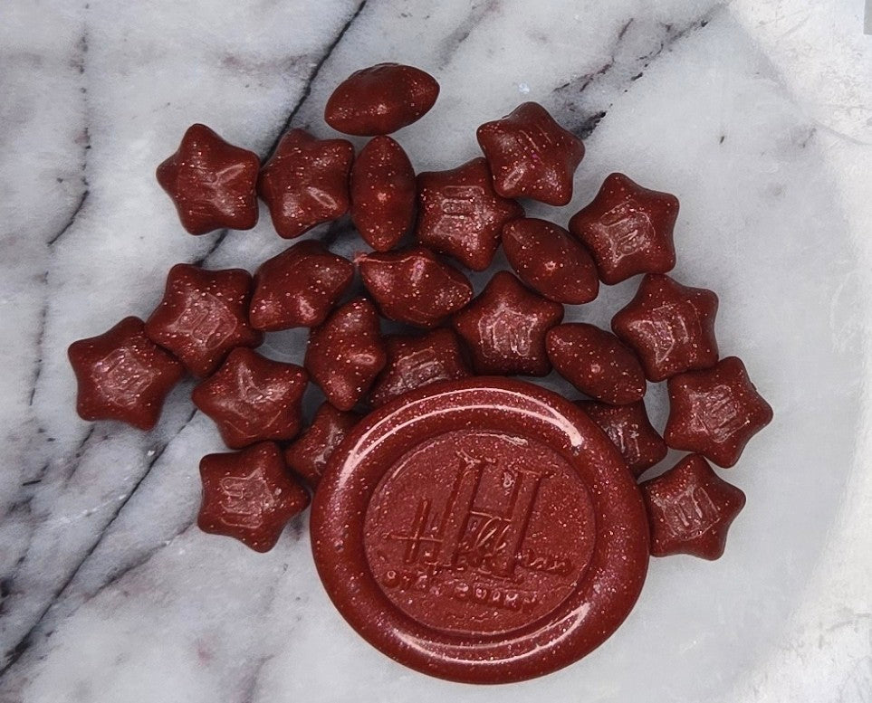 a fiery, intense crimson wax seal bead that blazes with bold energy (and gold glitter) and passionate flair