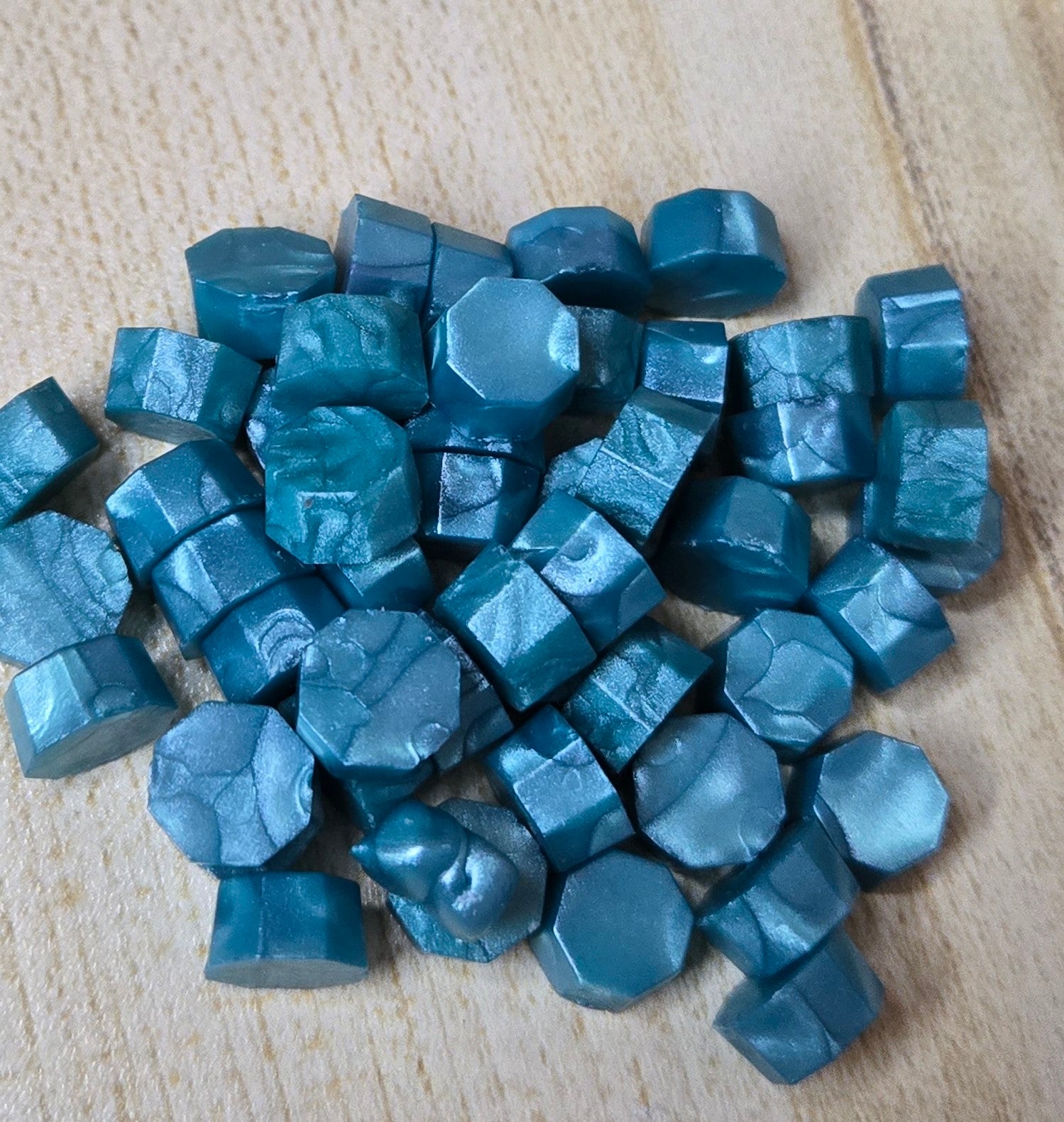 a radiant turquoise wax seal bead that gleams like sunlit glass, casting vibrant aquatic hues