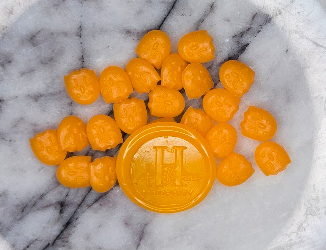 juicy, translucent orange wax seal bead bursting with zesty citrus vibes and a playful, jelly-like gleam